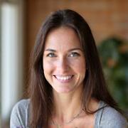 Portrait of Lisa Thompson, a mental health counselor, with a calm, reassuring smile.