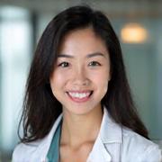 Portrait of Dr. Sarah Chen, a compassionate female physician, smiling confidently.