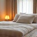 A cozy bedroom with soft lighting and clean sheets, representing optimal sleep environment.