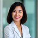 Portrait of Dr. Sarah Chen, a knowledgeable and approachable health professional, with a modern continuous glucose monitor device in the background, signifying her expertise.